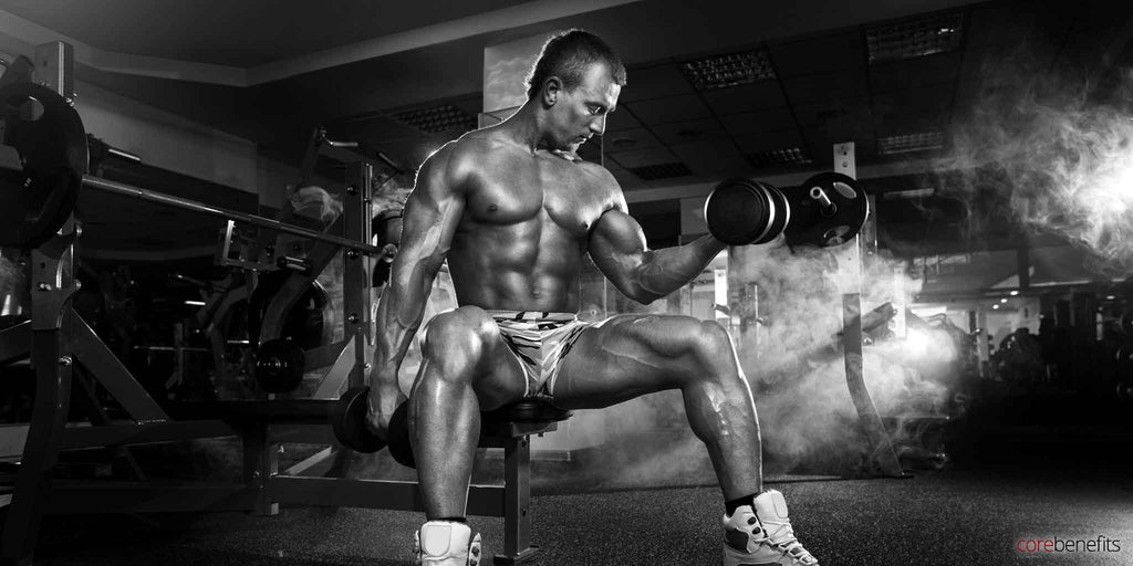 Concentrated man doing dumbbell curls in a gym, embodying the athletic spirit supported by sports massage at Core Benefits Toowoomba, a leader in men's sports massages in the area.
