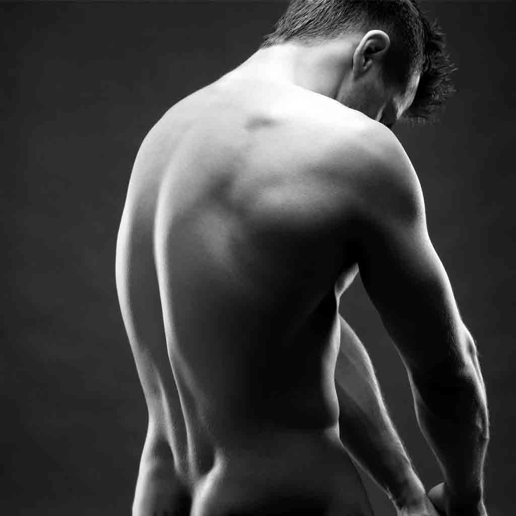A monochromatic side profile of a man's upper body, visually expressing the relief and rejuvenation that Toowoomba massage services offer. This image is reflective of the various massage techniques available, including remedial, sports, relaxation, and the traditional lomi lomi, all tailored for men's wellness.