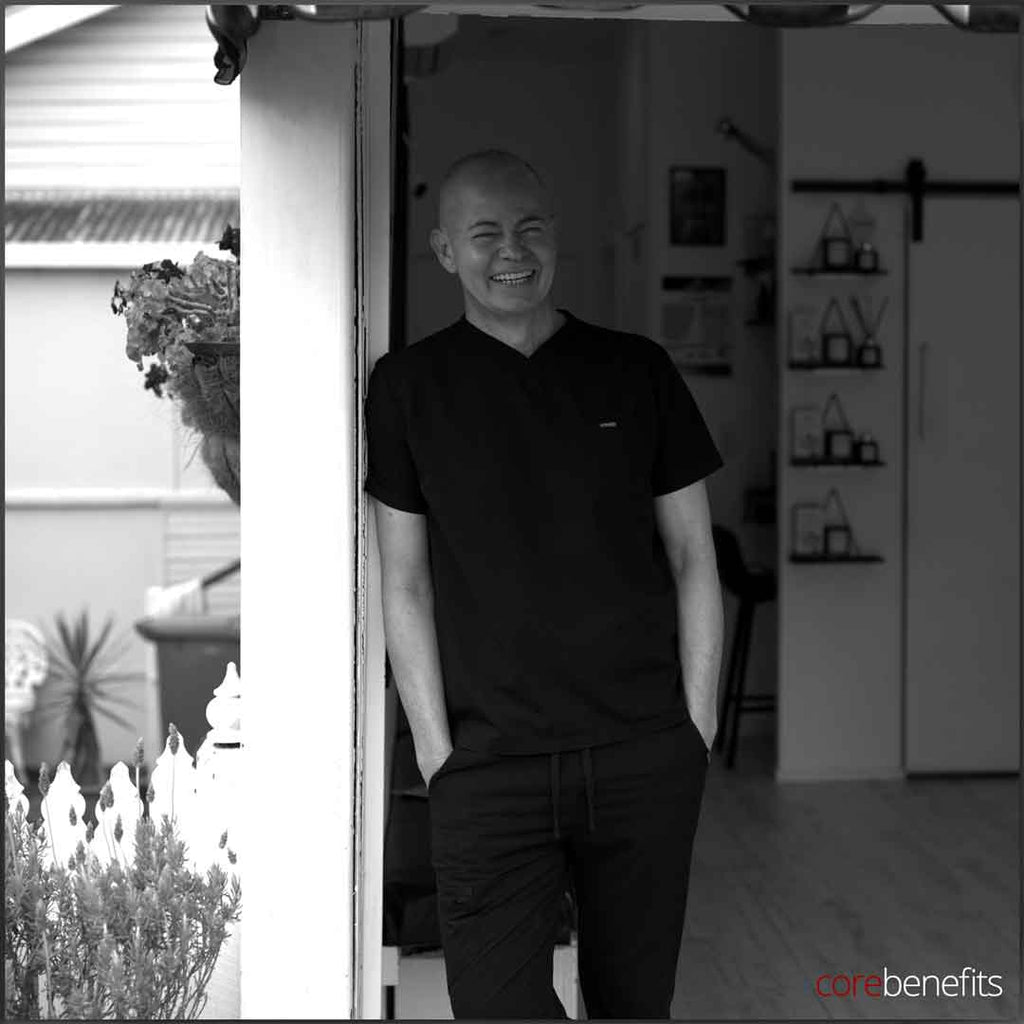 Welcoming smile of a male massage therapist at Core Benefits Toowoomba, dressed in professional attire, capturing the essence of 'Bare to Bold: Effortless Confidence Begins Here'. Visit for a rejuvenating massage experience in Toowoomba, where quality and care meet.