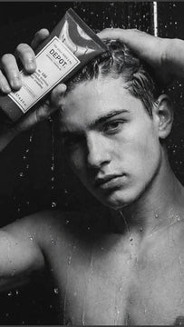Man shampooing hair in the shower with DEPOT No.106 Dandruff Control Intensive Shampoo formulated to help treat dandruff and soothe scalp irritation